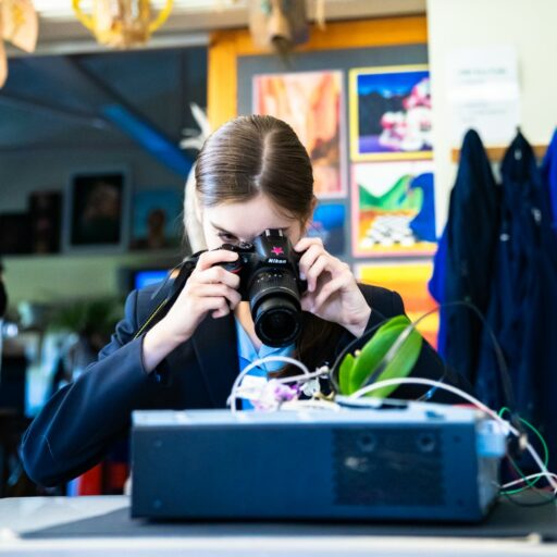 Senior school pupil in an art room at St Mary's Colchesterm with a campera taking photos for her schoolwork