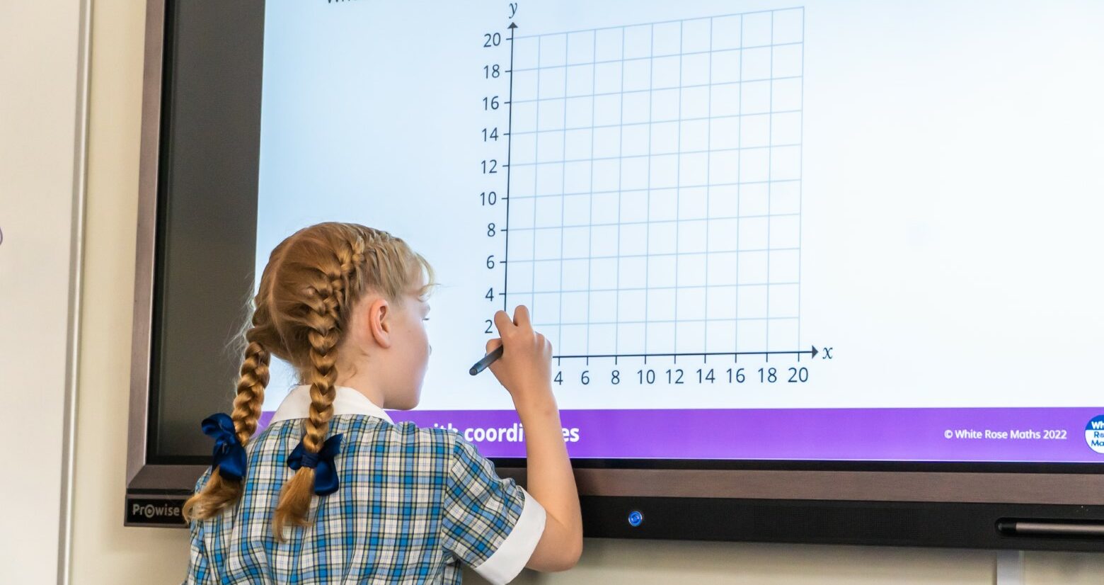 St Mary's Colchester pupil learning maths using an electronic white board in Essex