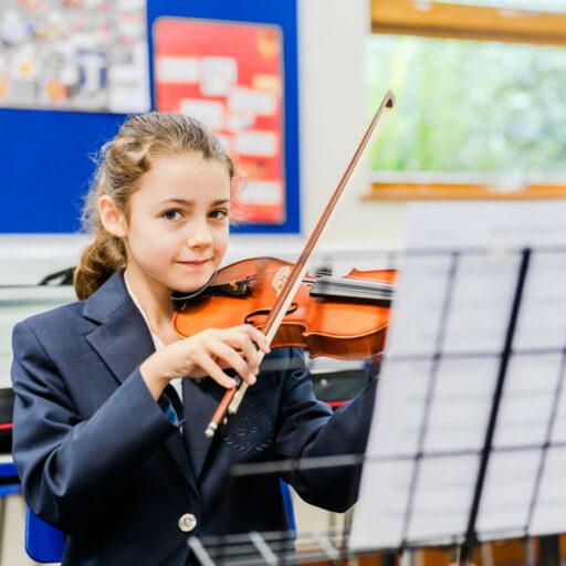 Senior school pupil playing the violin during a music lesson at St Marys Private School in Essex