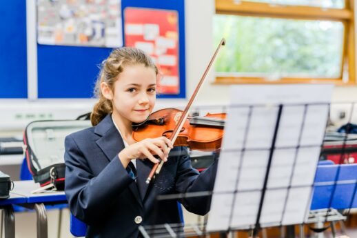 Senior school pupil playing the violin during a music lesson at St Marys Private School in Essex