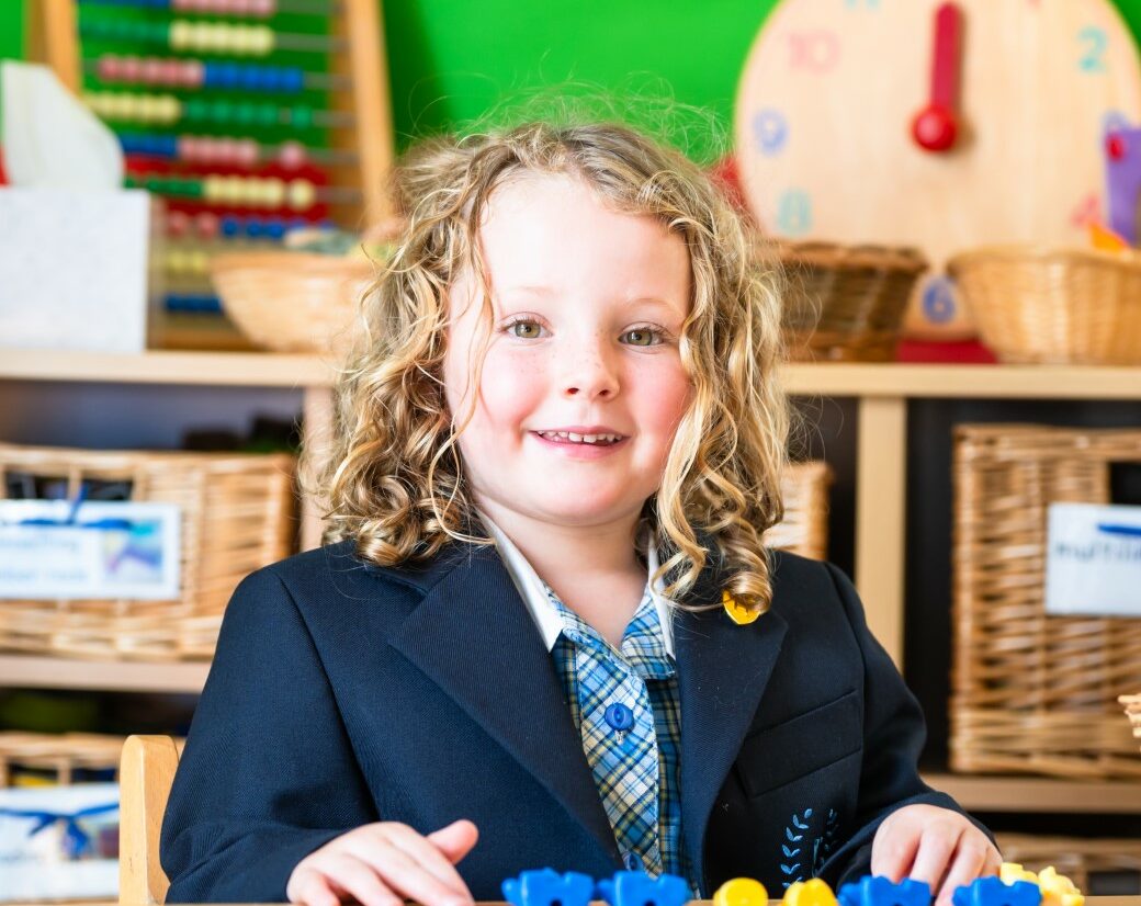 Reception pupil sitting in a classroom at St Marys Private School in Colchester